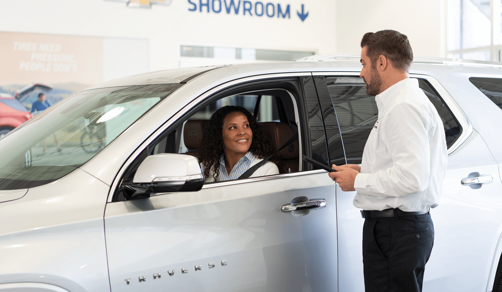 chevy finance professional greets smiling customer
