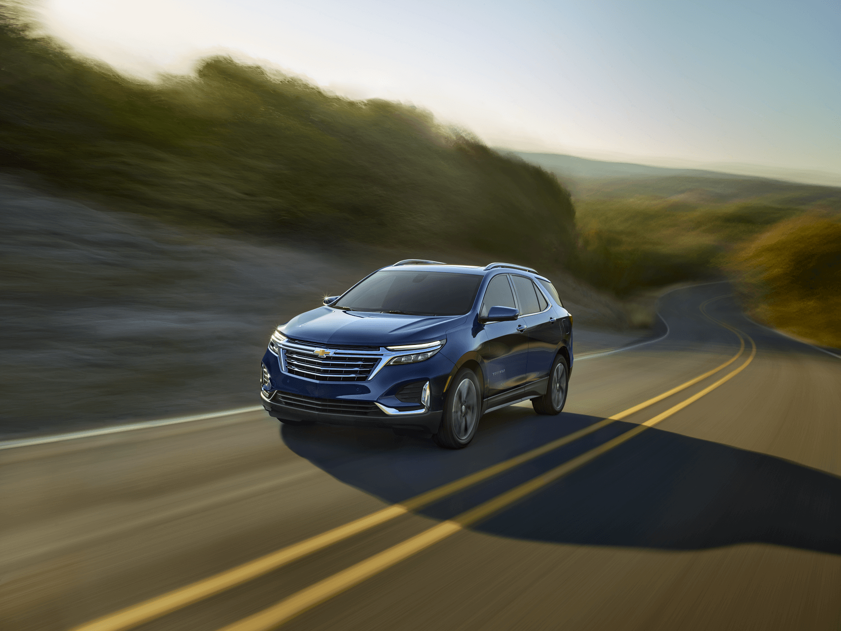blue chevy equinox driving down country road