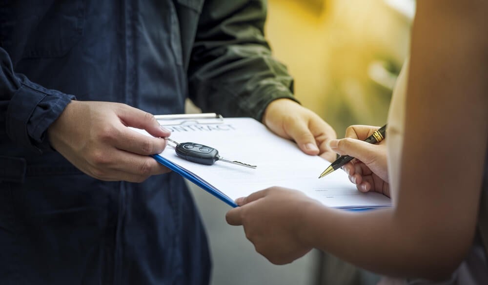 chevy mechanic helps customer with service paperwork